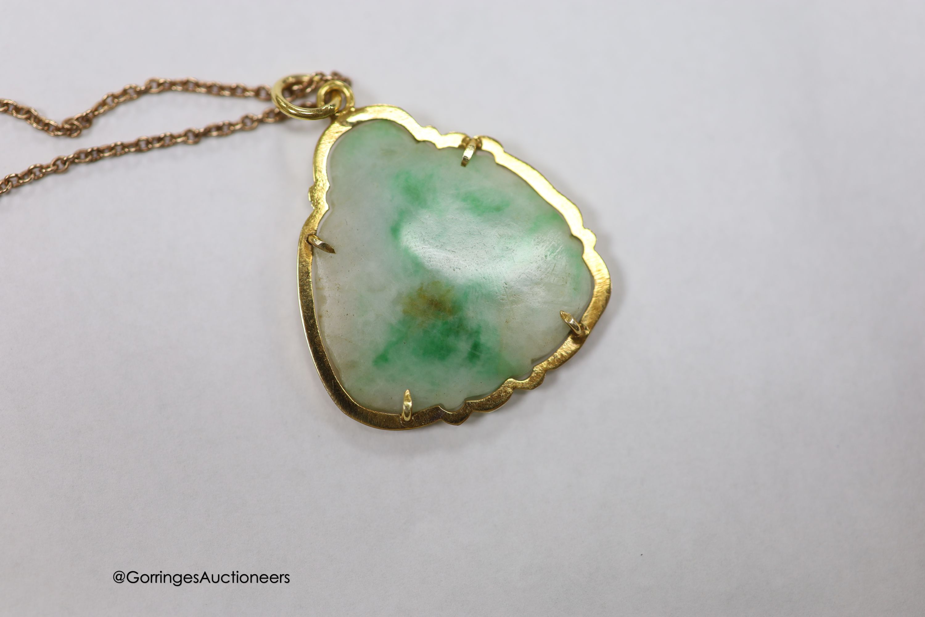A yellow metal mounted jade pendant, carved as a Buddha, 30mm on a 925 chain.